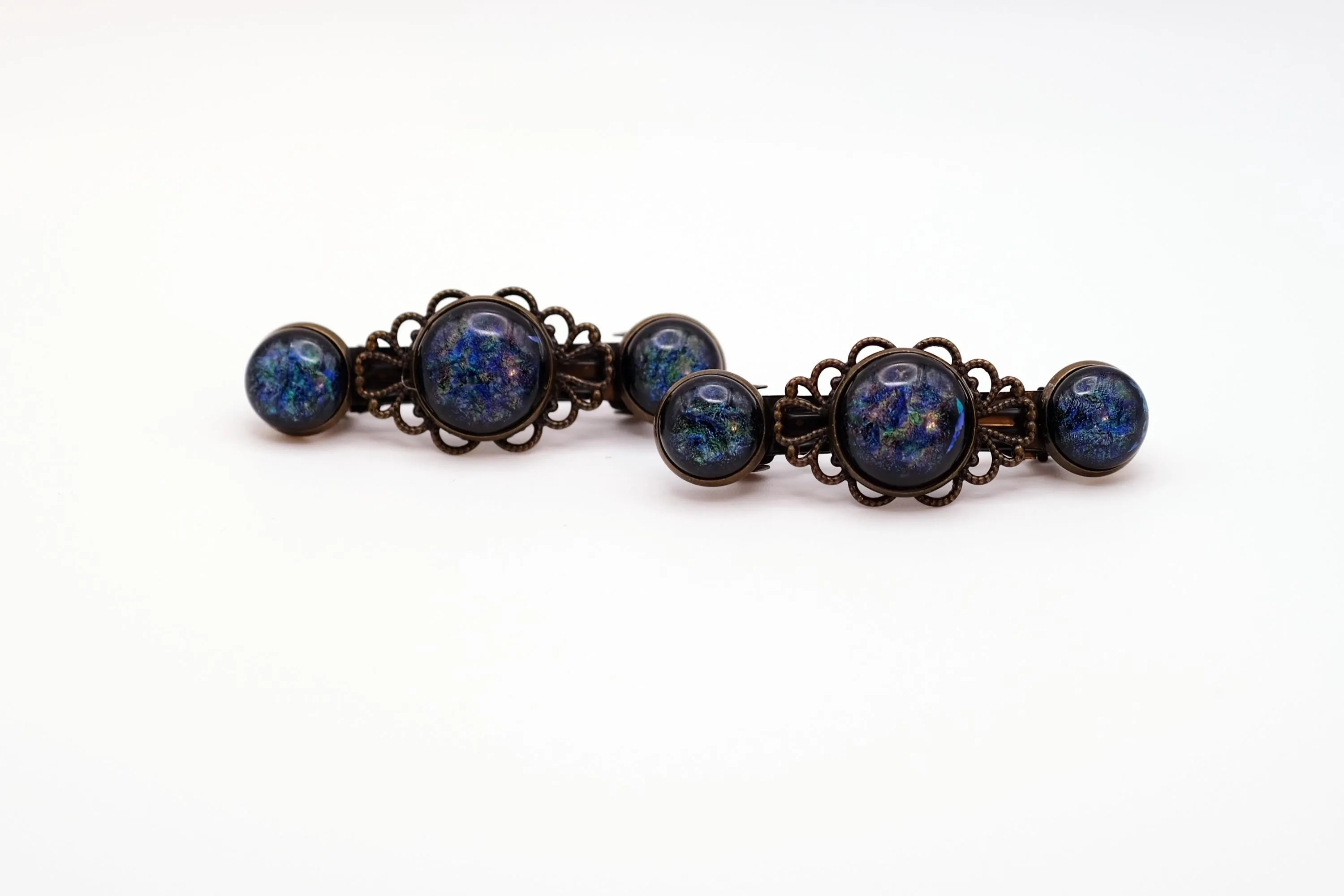 Barrette pair, bronze flowers with blue base and multicolor specs dichroic fused glass cabochons, french clip, 2 1/4 inches