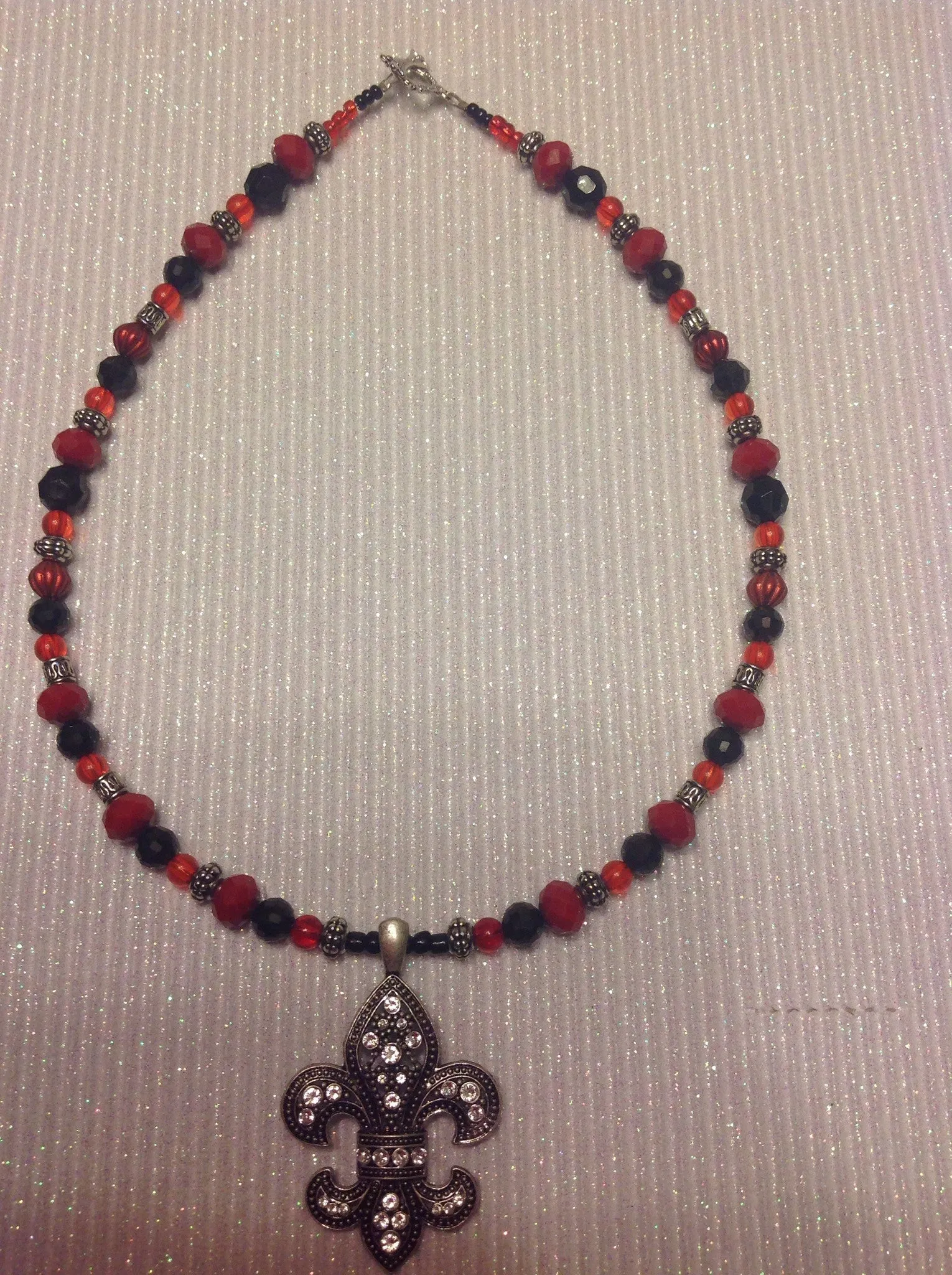 Red black and silver fleur de lis pendant necklace